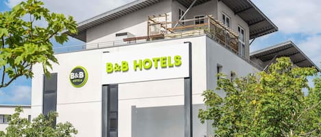A B&B hotel with a modern design, a reception area, and a balcony.
