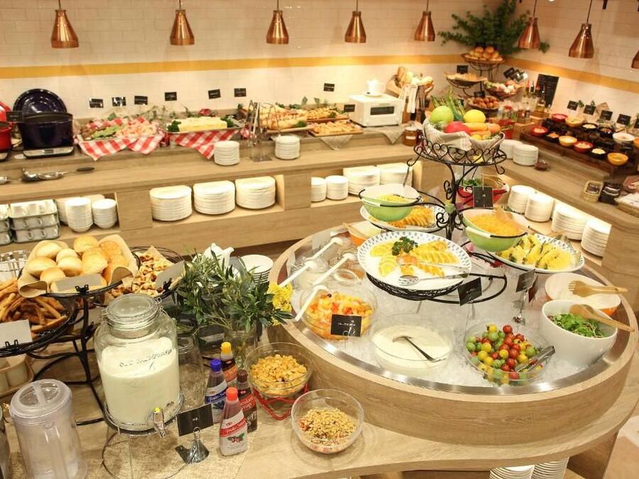 A buffet with various food items and condiments.