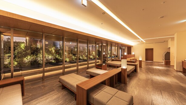 A modern interior with wooden benches and tables, large windows with a view of greenery, and a clean, well-lit space. - Tokyu Stay Fukuoka Tenjin (Fukuoka)