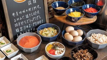 A variety of food items and ingredients displayed on a counter, including bowls of vegetables, eggs, and sauces.