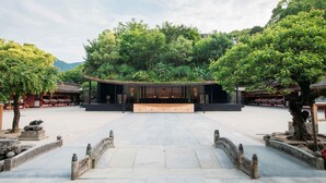 A traditional building with a central stage, surrounded by stone pathways and trees. - Tokyu Stay Fukuoka Tenjin (Fukuoka)