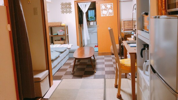 A compact living space with a kitchenette, a dining area, and a small bedroom. - Ryokoheya Tenchokan (Osaka)