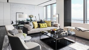 A modern living room with a sofa, armchairs, a coffee table, and a city view through large windows. - Niccolo Changsha (Changsha)