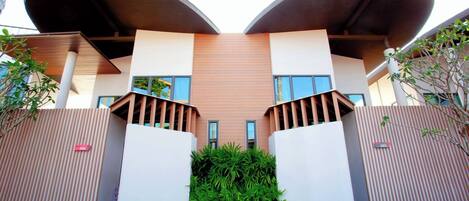 A modern building with a unique architectural design featuring two large, curved structures on the roof.