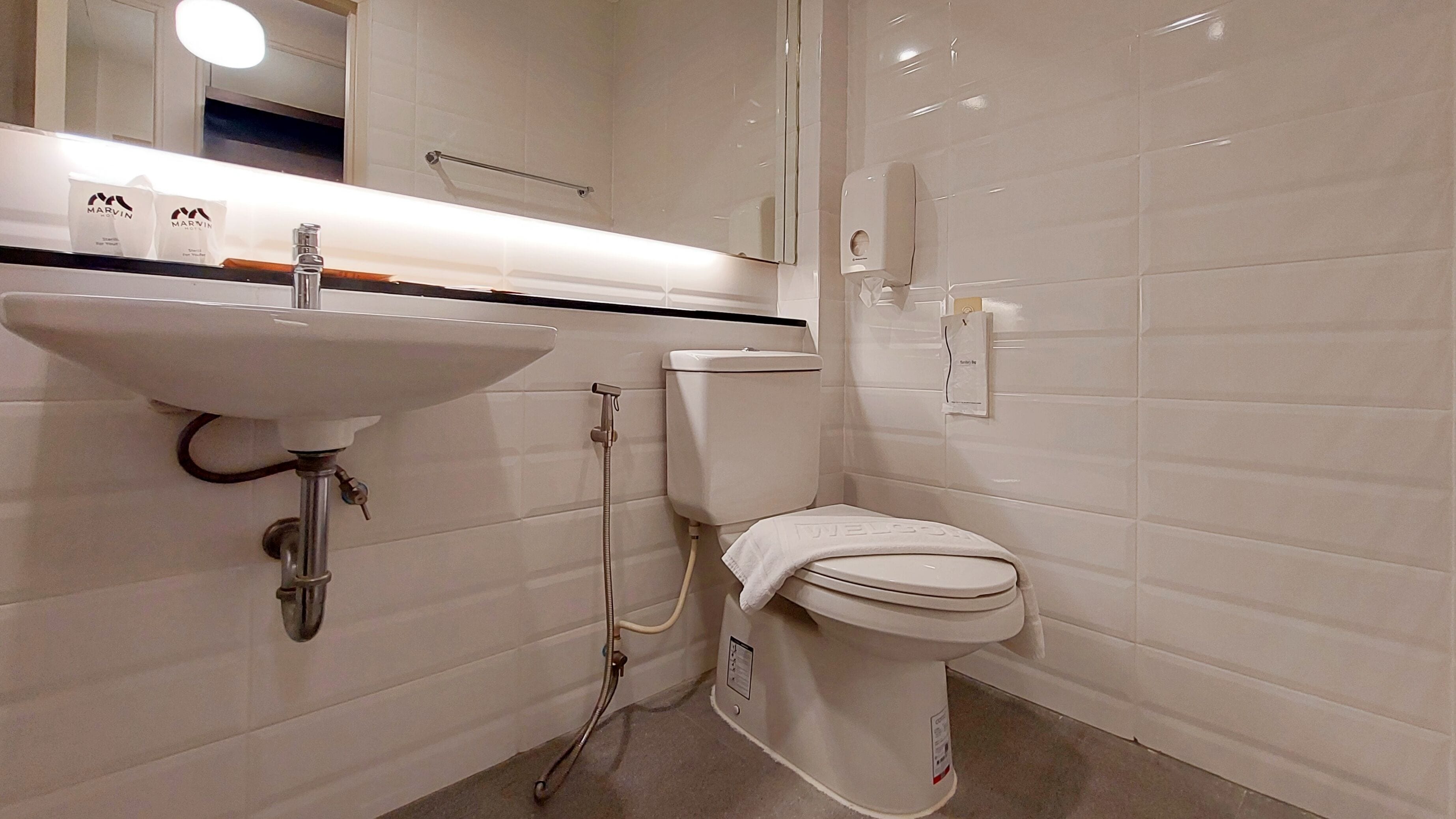 A bathroom with a white sink, toilet, and shower.