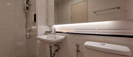 A bathroom with a sink, toilet, and shower.