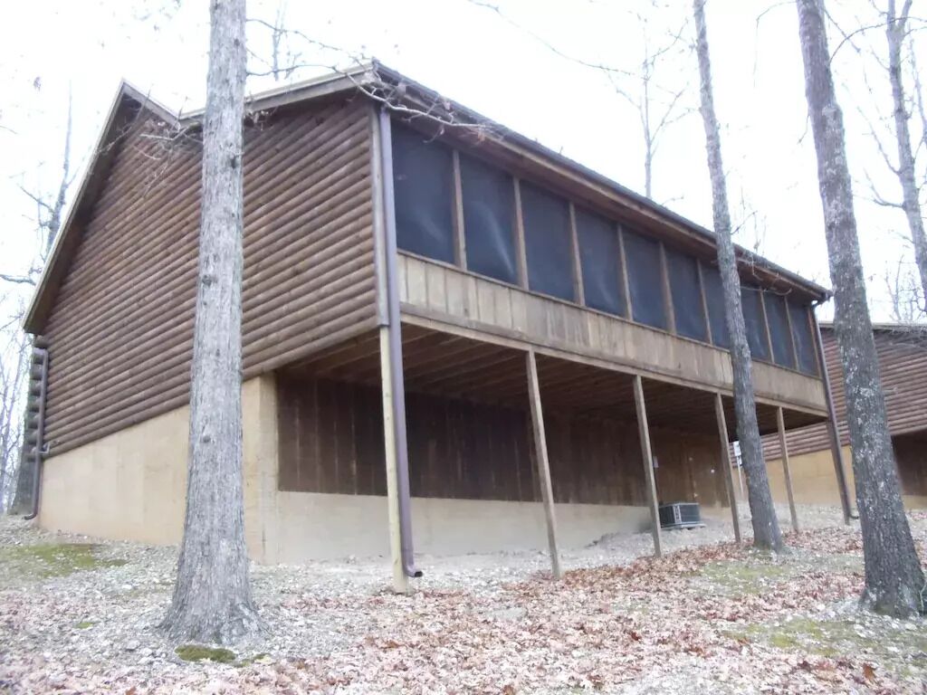A large, single-story building with a sloped roof and a covered porch area.