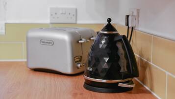 A toaster and a coffee maker on a kitchen counter.