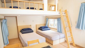 A dormitory room with two single beds, a wooden ladder, and a loft area with a window. - Shimizu Kuniaki’s Paradise of Forest and Lake (Fujikawaguchiko)