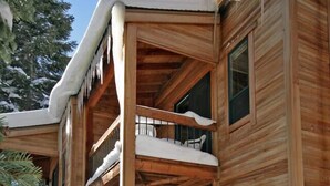 A wooden cabin with multiple balconies covered in snow, featuring a rustic architectural style. - IMMACULATE 3BR SKI TOWNHOME INSIDE NORTHSTAR RESORT! (Truckee)