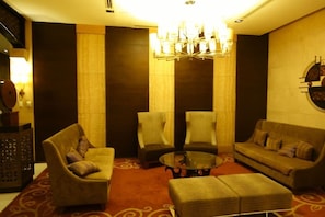 Relax in this inviting lounge area with a round table, armchairs, and a sofa.