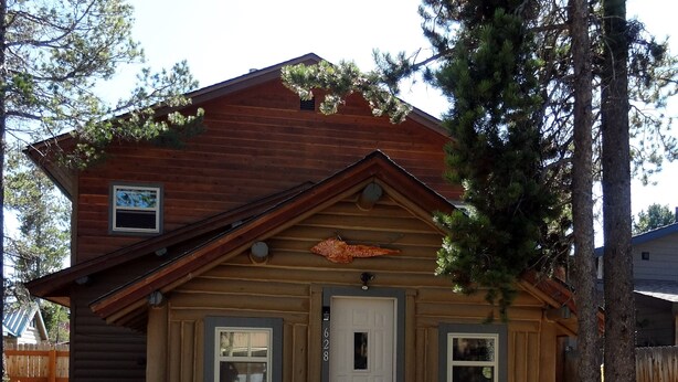 A small log cabin with a front door, two windows, and a porch. - WHISKEY SPRINGS CABINS #1
Cozy and delightful, in town convenience (West Yellowstone)