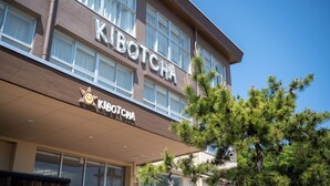 A hotel named "KIBOTCHA" with a modern facade, large windows, and a sign with a sun icon. - Kibotcha - Hostel (Higashimatsushima)