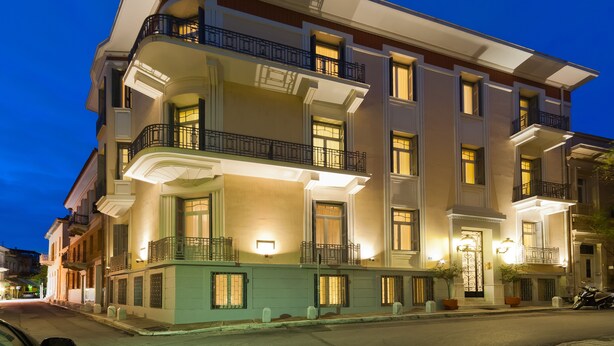 A multi-story hotel with balconies, large windows, and a well-lit facade. - Hapimag Resort Athens (Athens)