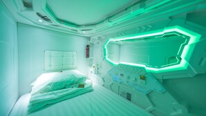 A futuristic room with a bed, control panels, and a geometric light fixture. - 24h Saigon Hotel (Ho Chi Minh City)