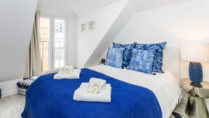 A bedroom with a large bed, two bedside tables, a window, and a lamp. - LxWay Apartments Old Town (Lisbon)
