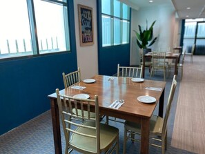 A conference room with a long table, chairs, and a large window. - The Lanes Hotel (Tutong)
