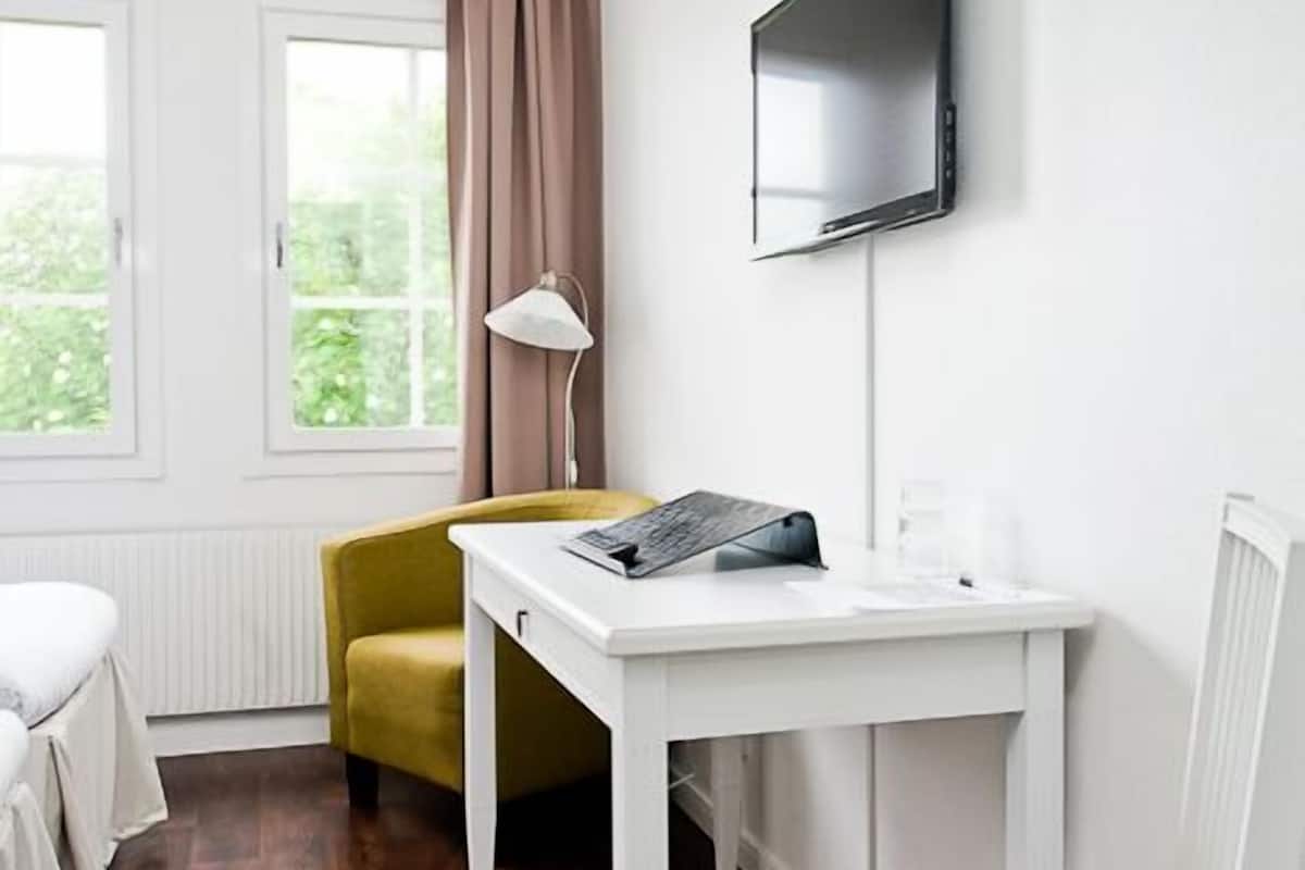 minibar, desk, blackout curtains, iron/ironing board