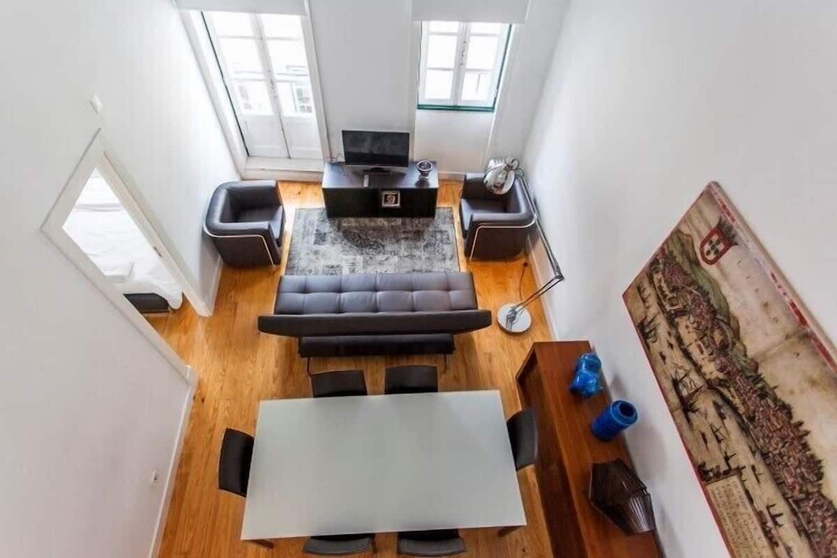 A modern living room with a sofa set, a coffee table, and a TV.