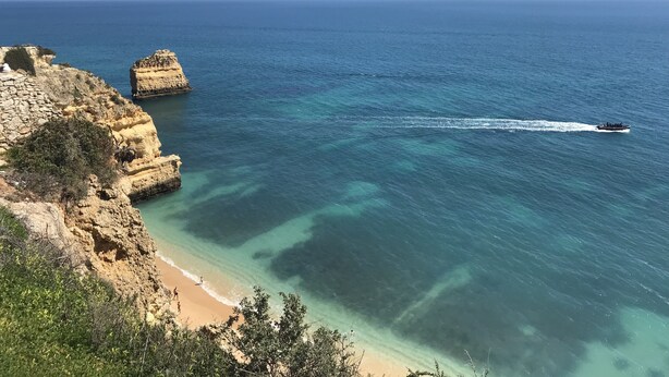 A coastal landscape with rocky cliffs, clear blue sea, and a sandy beach. - Algarve luxury seaview apartment with pool near beaches  (Porches)