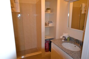 Bathtub, hair dryer, towels, shampoo