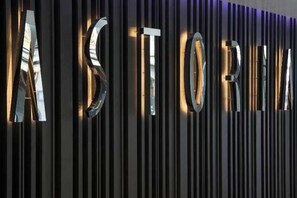 A metallic wall with the word 'ASTORIA' illuminated in large letters. - Hotel Astoria (Lucerne)