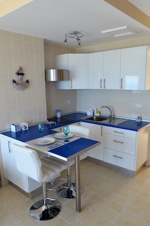 Fridge, microwave, stovetop, coffee/tea maker