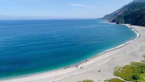 Een kuststrand met een helder uitzicht op de oceaan en een zandstrand.