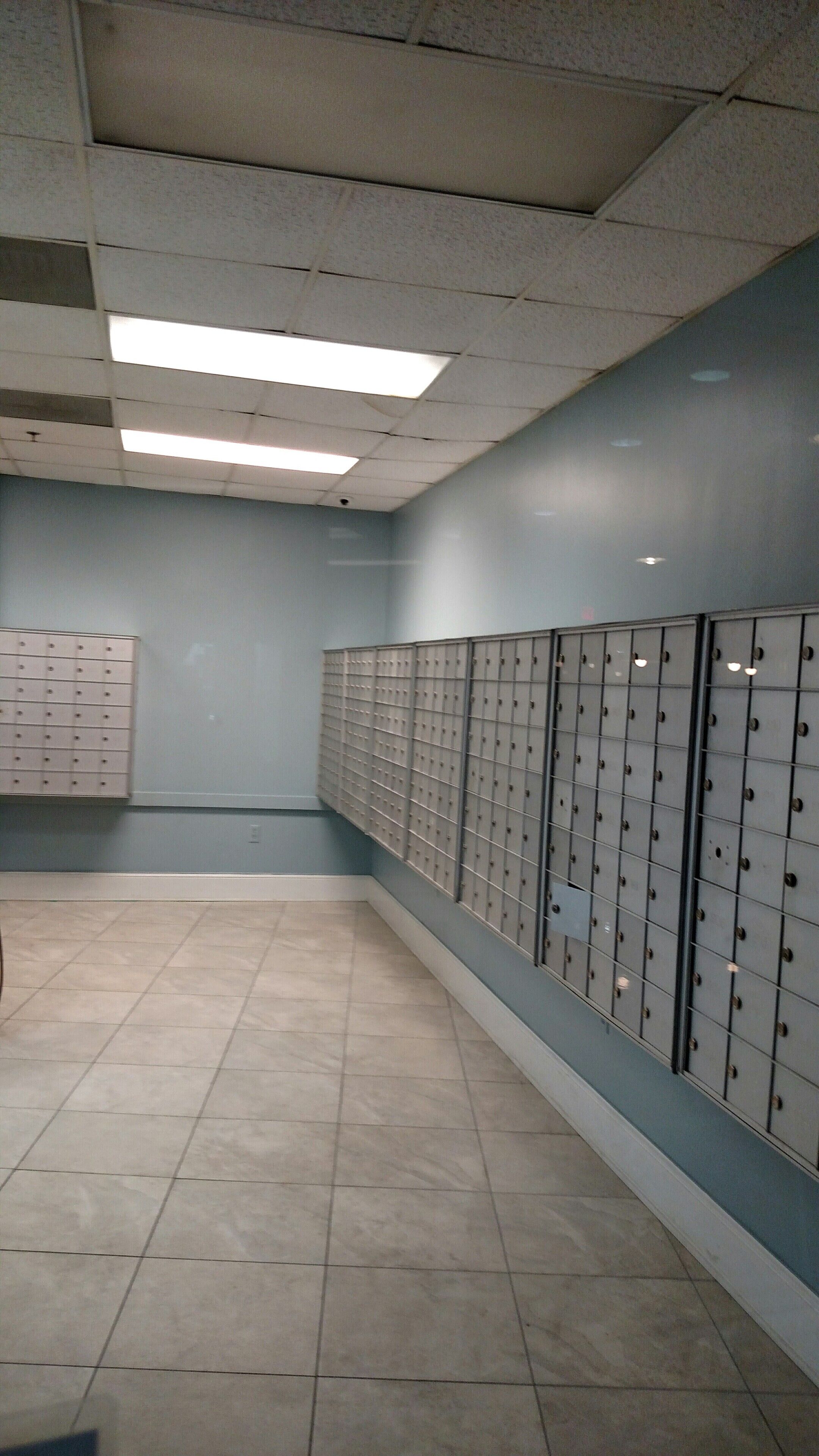 A locker room with multiple lockers along the walls and a tiled floor.
