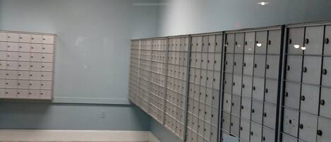 A locker room with multiple lockers along the walls and a tiled floor.
