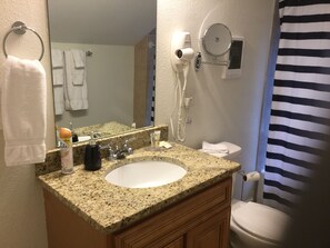Bathtub, hair dryer, towels, soap
