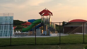 A playground with slides and a red-roofed structure. - Relaxing! Professionally Cleaned, Self Check In - Sleeps 12 (Racine)
