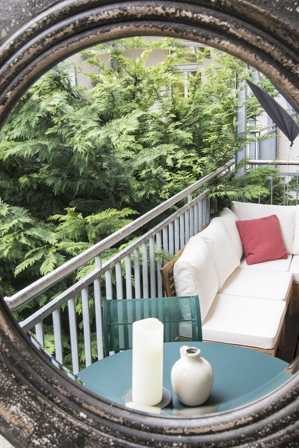 Relax on the balcony with a serene view of the lush garden.