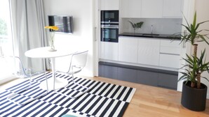 A modern kitchen with white cabinets, a black oven, and a stainless steel sink. - Ripple - near Congress Centre & River- A/C, swimming, pool, secure parking (Lisboa)