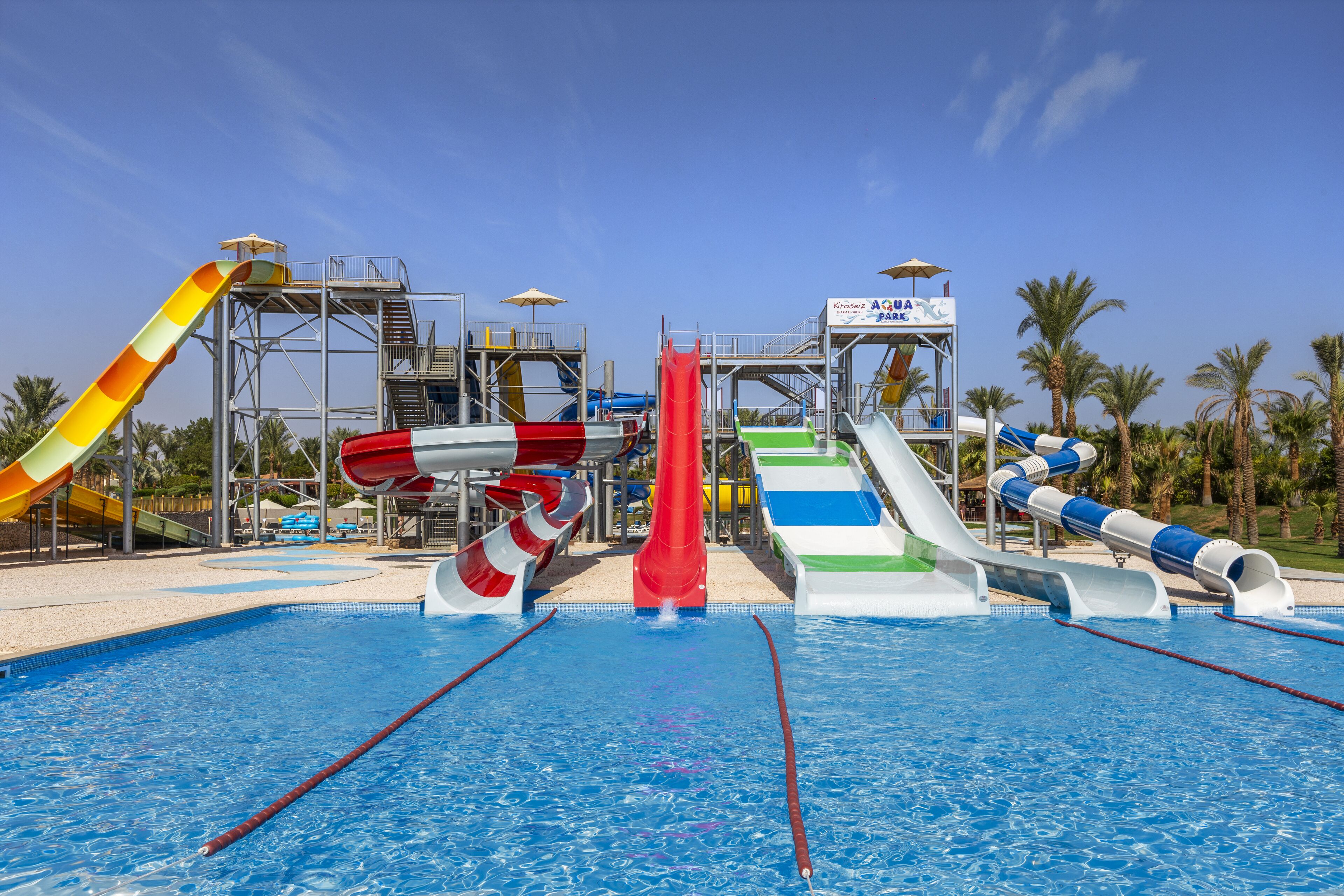 A water park with multiple slides and a pool.