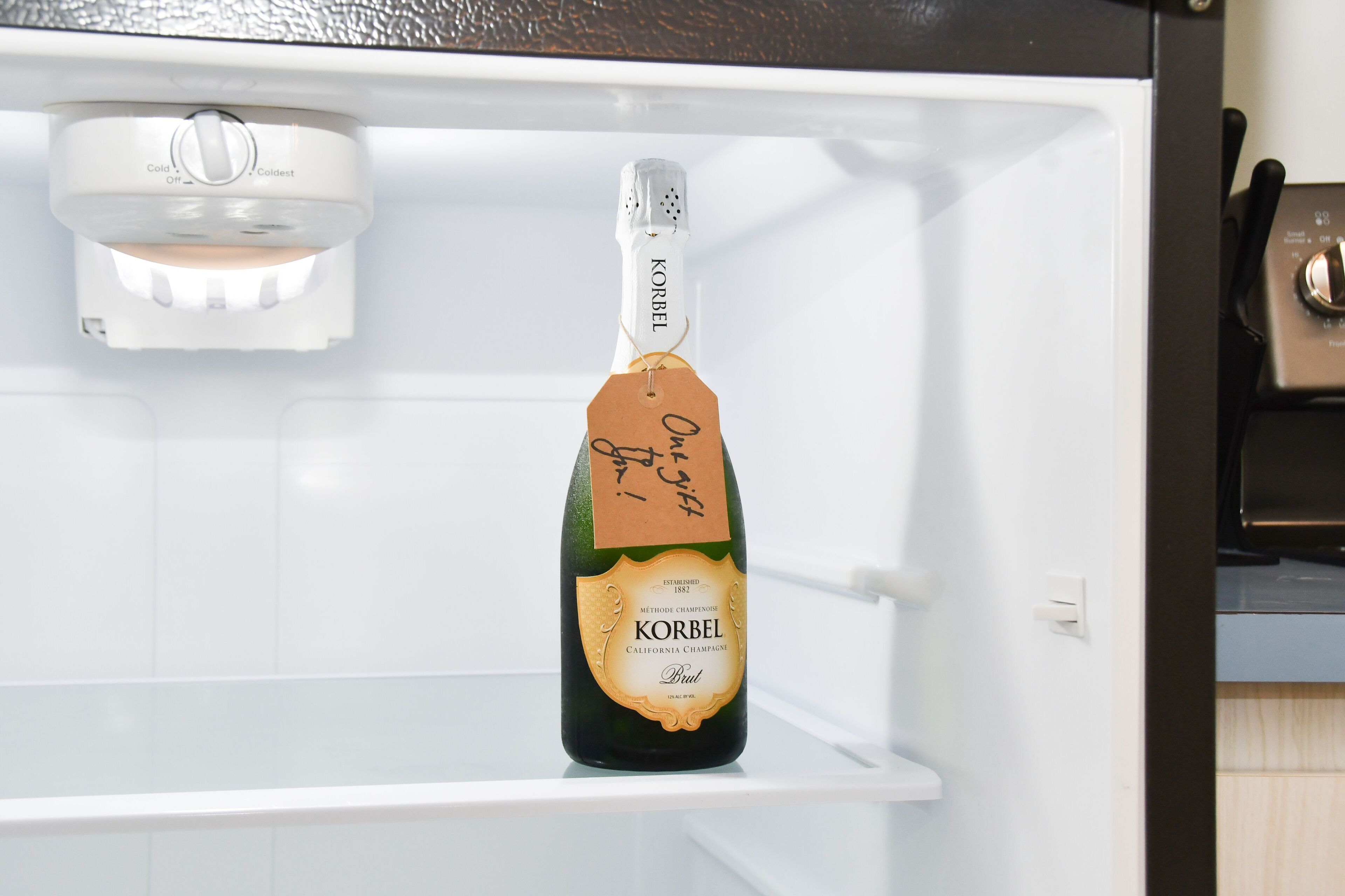 A bottle of Korbel champagne in a refrigerator.