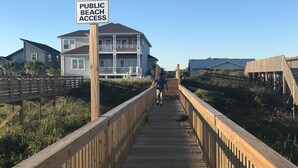 A wooden boardwalk leading to a beach with a sign indicating public beach access. - 4 Bed 3.5 Bath Pool Mid Island, Quiet Garden lined Street, steps from the Beach! (Ocean Isle Beach)