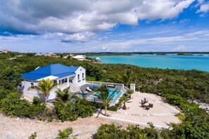 Enjoy a scenic ocean view from this two-story property surrounded by lush greenery and a pool.