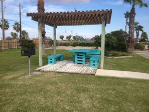 A gazebo with a wooden roof and turquoise benches. - Sands of time,VIEW 180°, PEACEFUL,360° VIDEO,WIFI, CABLE,ROKU,DVDS, FALL CHEAPER (Corpus Christi)