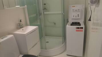 A bathroom with a toilet, sink, and glass-enclosed shower.