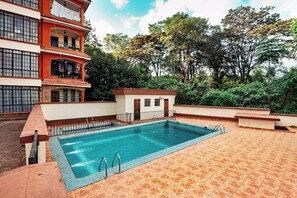 Relax by the pool surrounded by lush greenery and take in the views from the adjacent balconies.