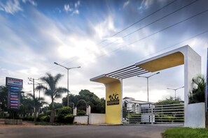 The entrance to R.G. Hotels & Resort with a prominent yellow archway and a gated entrance.