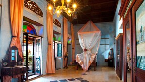 A hallway with a chandelier, curtains, and a canopy. - Emerson Spice Hotel (Zanzibar Town)