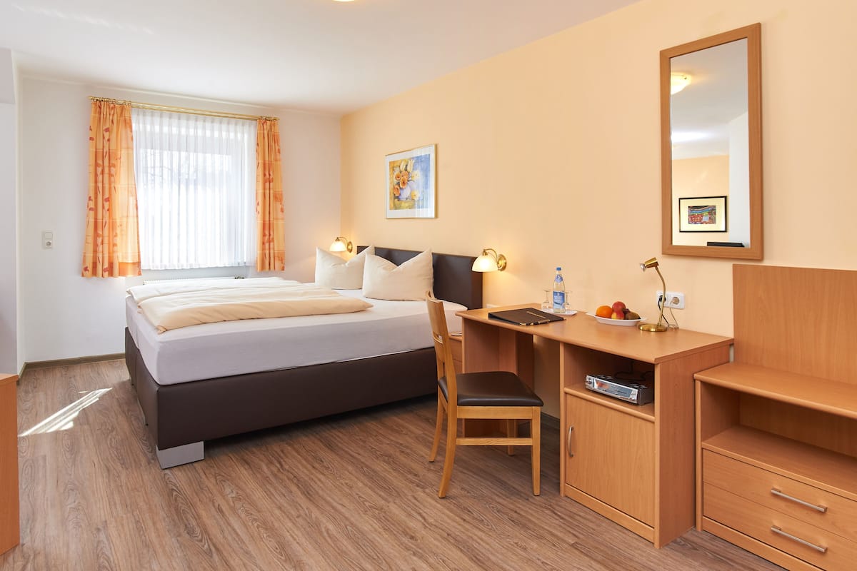 Hypo-allergenic bedding, desk, laptop workspace, blackout curtains
