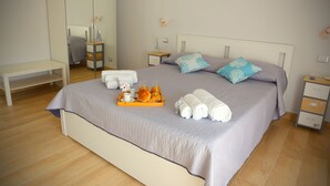 A neatly made bed with a tray of breakfast items, towels, and pillows. - Maribà (Agrigento)