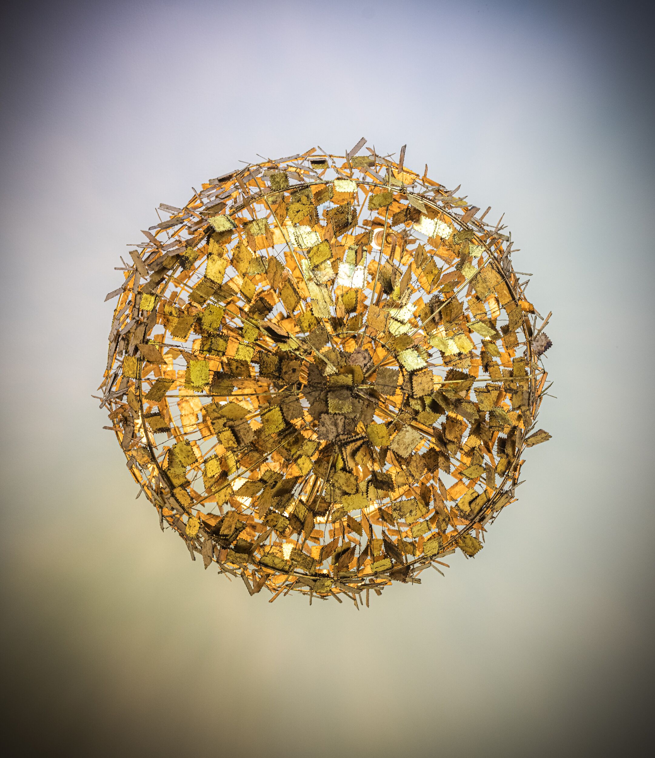 A spherical structure composed of various materials, possibly for artistic or decorative purposes.