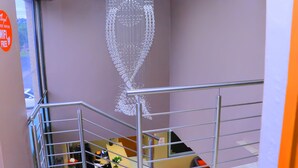 A staircase with a modern chandelier and a sign indicating free WiFi. - Angel Guest House (Johannesburg)
