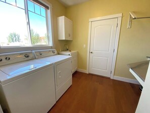 A laundry room with a washer, dryer, and a sink.