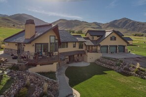 Enjoy a spacious deck and covered patio area, perfect for entertaining guests, with a beautiful view of rolling hills.