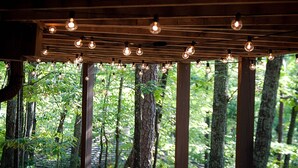 A wooden ceiling with exposed beams and string lights.